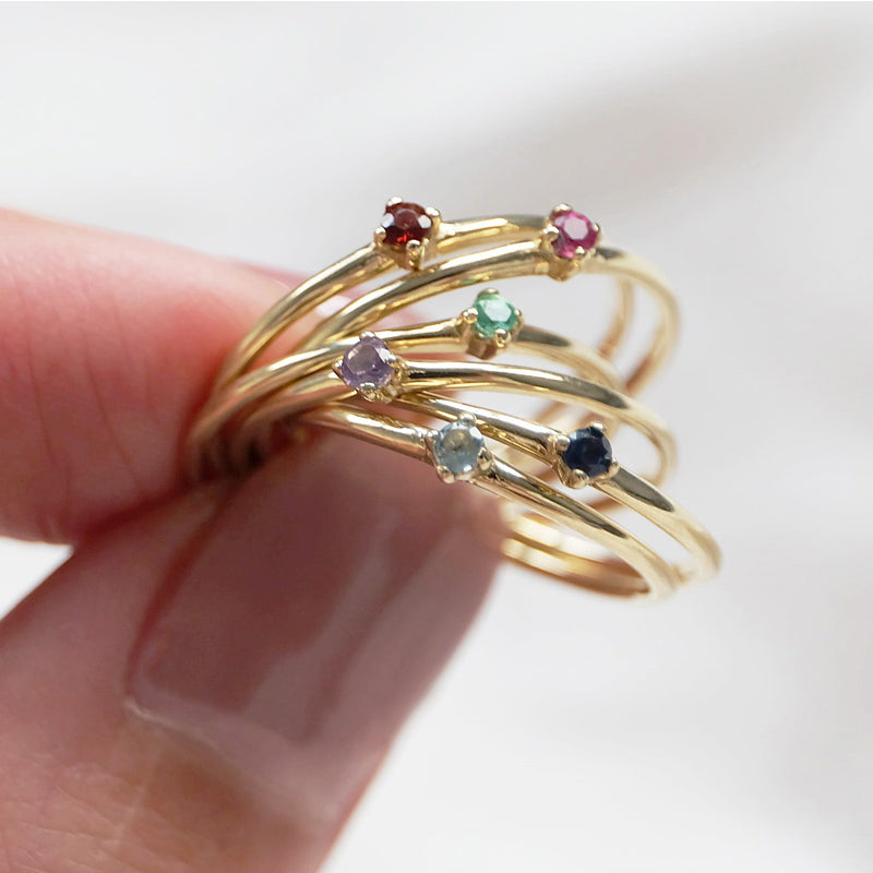 A ring with popular gemstones on a woman's hand