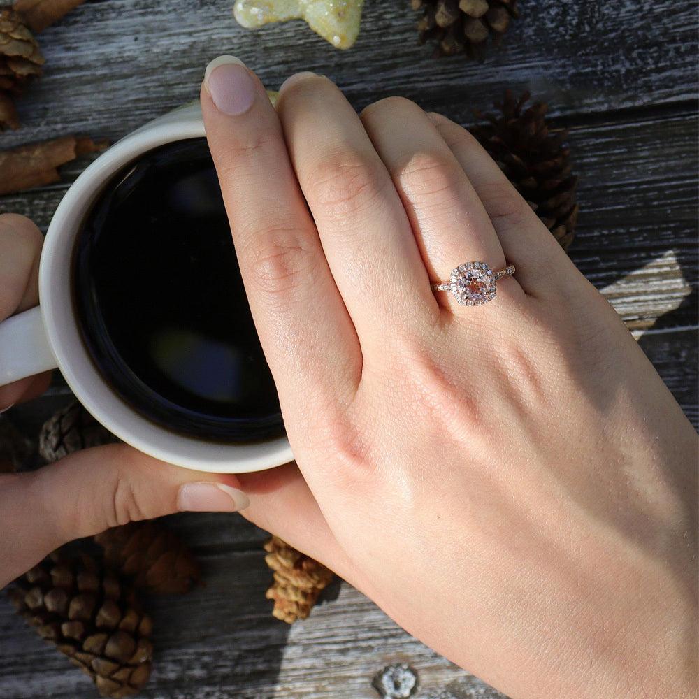 lab grown vs natural diamond -A hand holding a mug of coffee with a moissanite, diamond, or lab diamond ring on their right hand