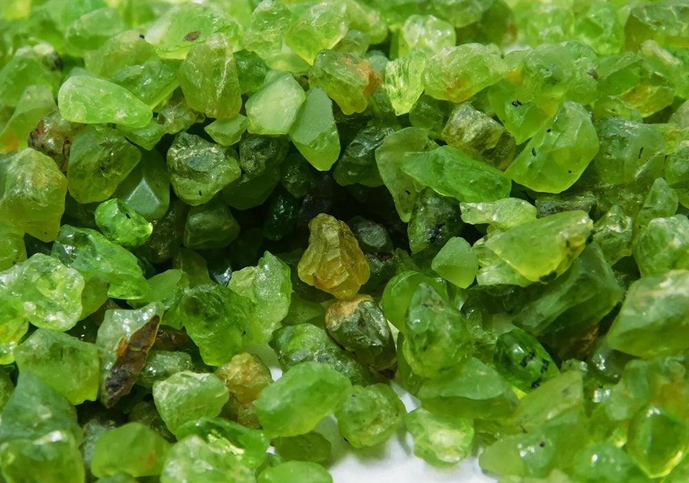 a close-up of several pieces of uncut peridot