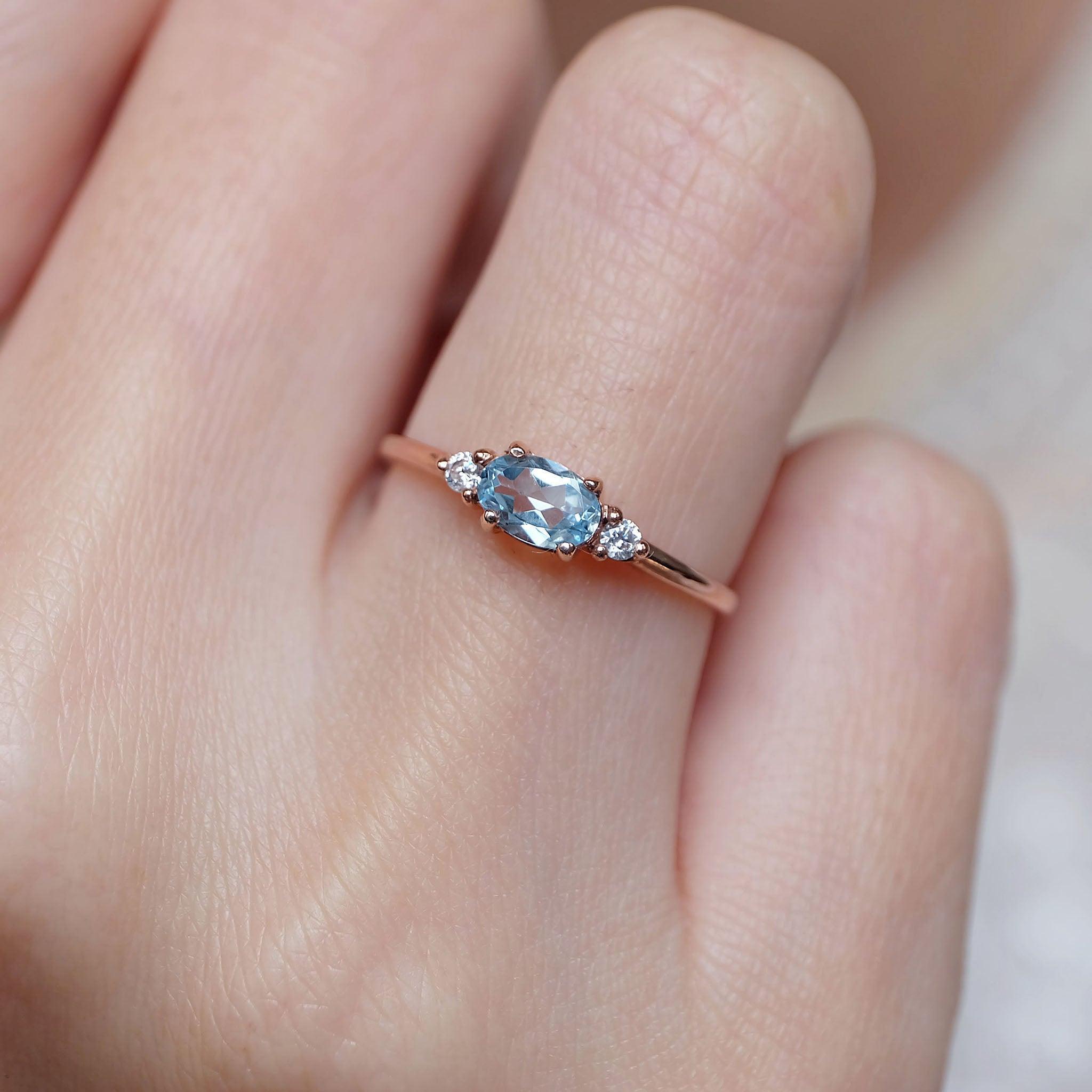 An aquamarine diamond ring worn on the right hand