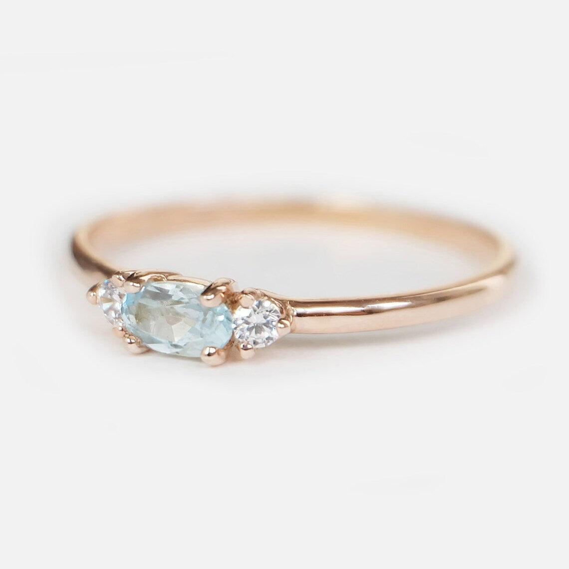 Aquamarine ring with diamonds angled to the viewer's left